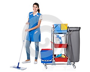 Happy Female Janitor Mopping By Trolley On White Background
