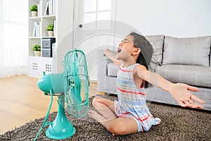 Happy female kid opening arms enjoying cool wind