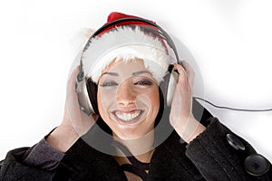 Happy female listening music and wearing christmas