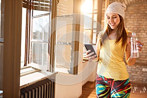 Happy female looking on cell phone indoor