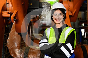 Happy female maintenance engineer worker working at industrial factory