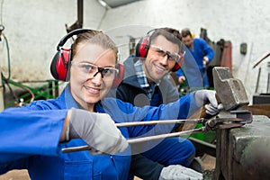 happy female metal worker during training