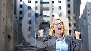 Happy female office worker celebrating success showing yes gesture, achievement