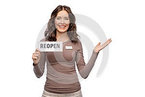 happy female shop assistant with reopen sign