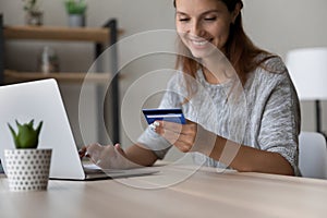 Happy female shopping online with credit card