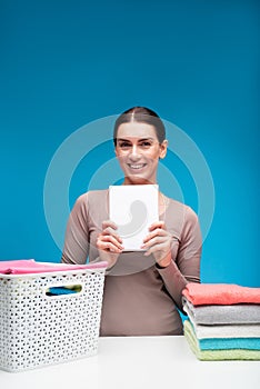 Happy female showing the best detergent for linens