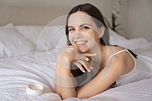 Happy female showing funny heart of moisturizing cream on hand