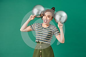 Happy female with smiling, having fun with two silver ballons