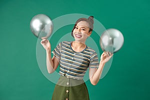 Happy female with smiling, having fun with two silver ballons