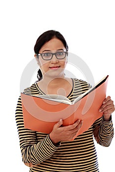 Happy female student holding text book