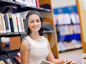 Happy female student at the library