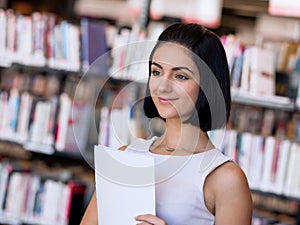 Happy female student at the library