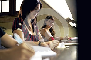 Happy female student smiling at camera in college library