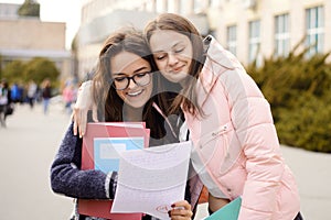 Happy female students with excellent test result