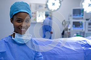 Happy female surgeon sitting in operation theater