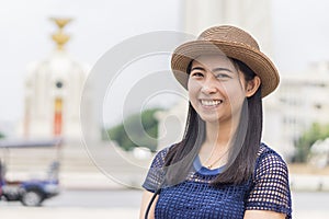 Happy female take a picture at Bangkok Democracy Monument - Concept of joyful travel