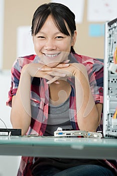 happy female technician fixing computer