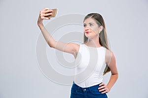 Happy female teenager making selfie photo