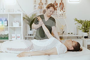 happy female therapist in massage cabinet doing checkup