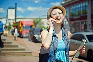 Happy female tourist communicating on telephone