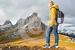 Happy female tourist enjoys the Alps