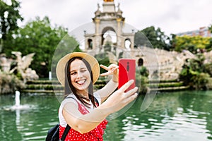 Happy female tourist taking selfie in Barcelona
