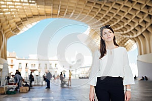 Happy female tourist visiting Setas de Seville aka Metropol Parasol, site seeing attractions.Vacation in south of Spain.Andalucia photo