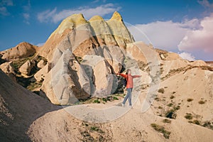 Happy female traveler on Cappadocia landscape