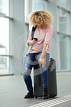 Happy female traveler laughing at text