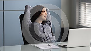 Happy female worker relax at workplace with eyes closed