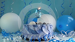 Happy fifth birthday navy cake and number five candle with blue balloons