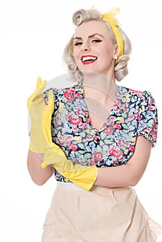 Happy fifties housewife putting on rubber gloves, humorous concept, isolated on white