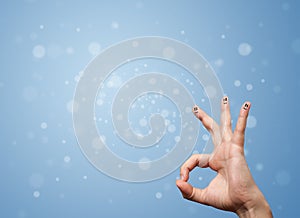 Happy finger smileys with empty blue bokeh background