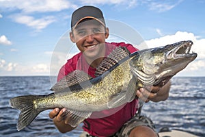 Happy fisherman with big zander fish trophy