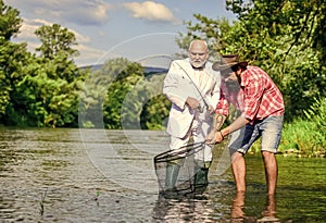 happy fishermen friendship. Catching and fishing concept. Two male friends fishing together. retired dad and bearded son