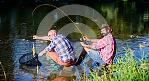 Happy fishermen friendship. Two male friends fishing together. big game fishing. relax on nature. fly fish hobby of men