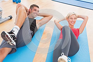 Happy fit couple working on exercise mat