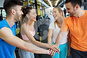 Happy fit friends having a sports greeting afther workout at the gym.