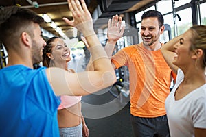 Happy fit friends having a sports greeting afther workout at the gym.