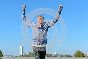 Happy fit man cheering and celebrating