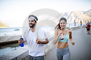 Healthy sporty lifestyle. Happy fit people friends exercising and running outdoor