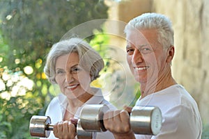 Happy fit senior couple exercising