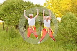 Happy fit senior couple jumping