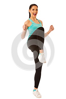 Happy fit and slim woman dancing and jumping isolated over white