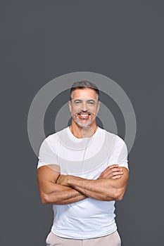 Happy fit sporty older man personal trainer isolated on gray, vertical portrait.