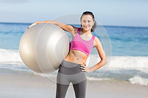 Happy fit woman holding exercise ball