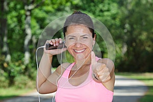 happy fit woman outdoors with thumb up