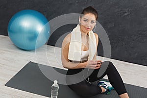 Happy fitness woman having rest in gym