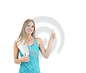 Happy fitness woman pointing to copy space