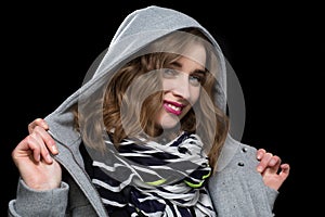 Happy flirtatious woman in a hooded jacket photo
